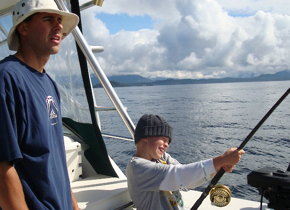 Boy fishing with guide near Tofino Canada