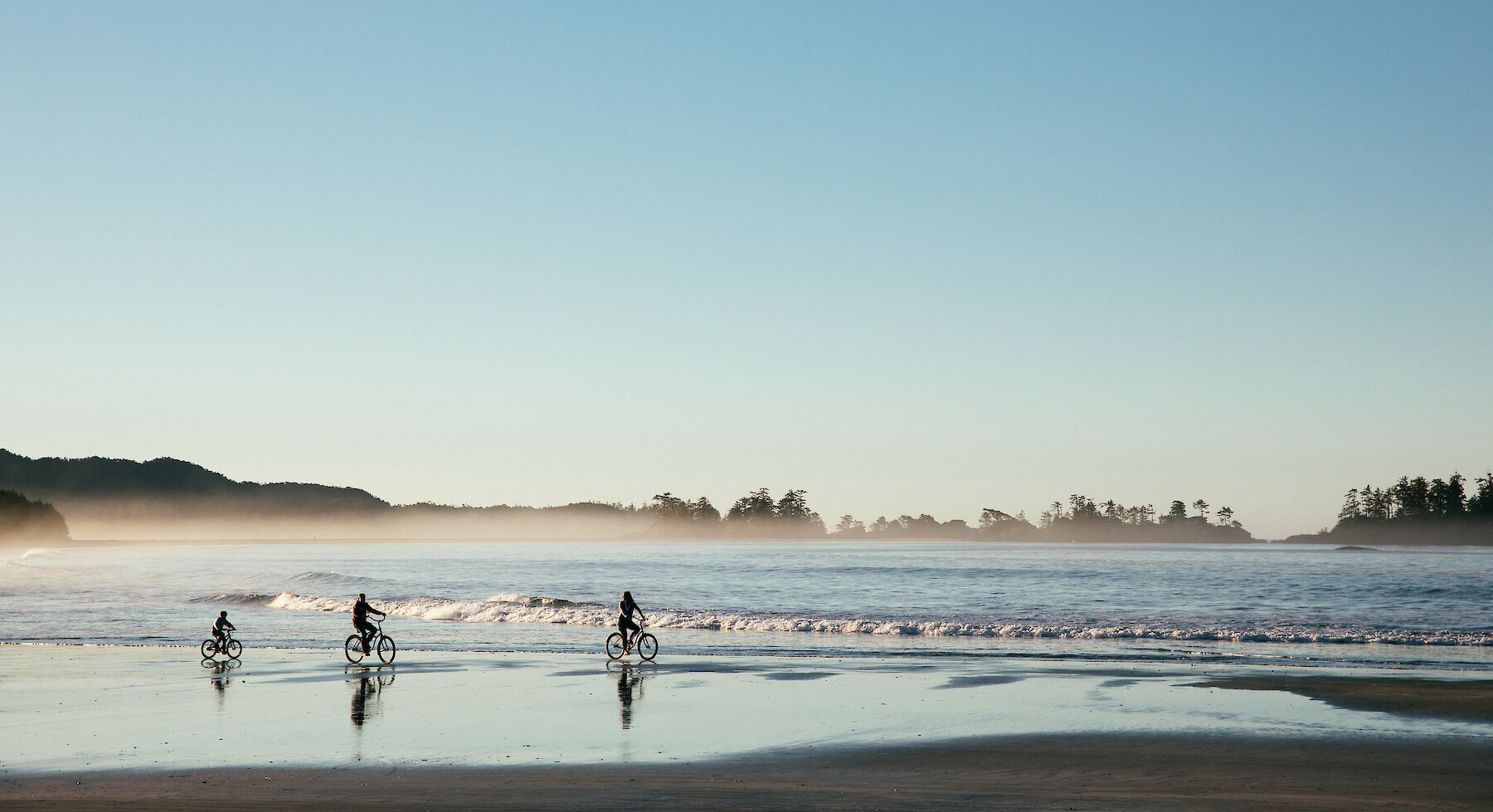 Family biking on Chesterman Beach